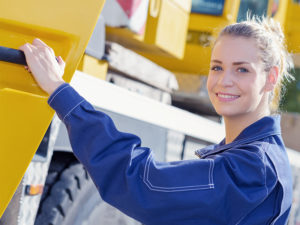 Portrait of woman holding door of truck