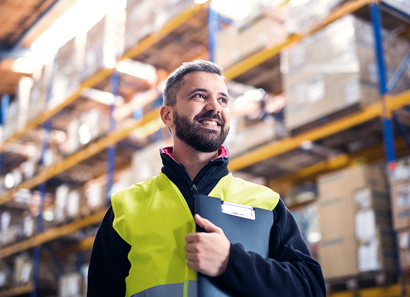 Male warehouse worker with clipboard.