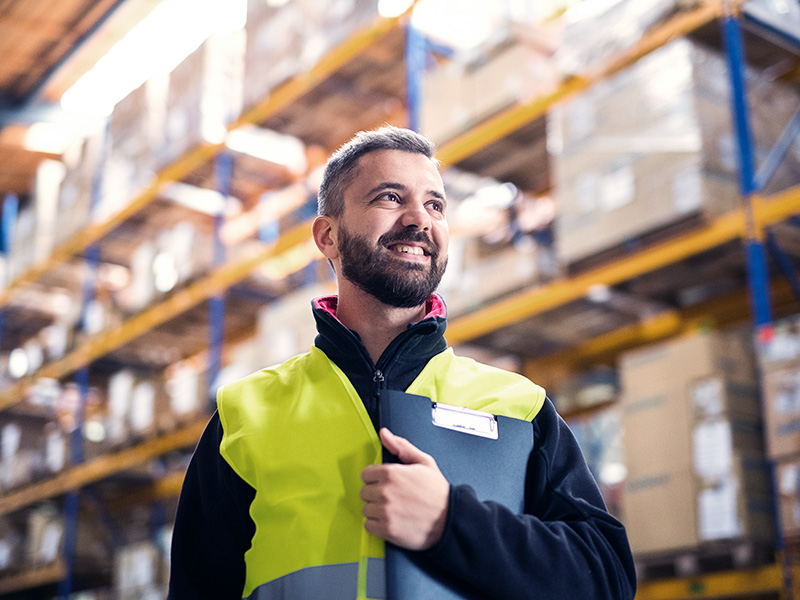 Male warehouse worker with clipboard.