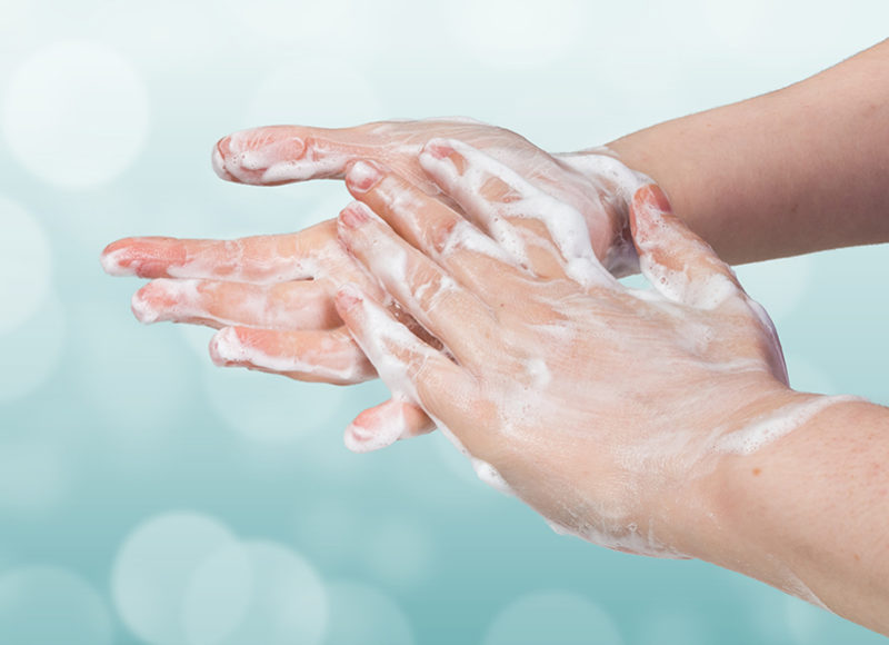 Washing hands. Hygiene concept. Blue bokeh background.