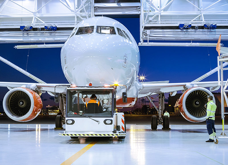 Aircraft Maintenance Hangar Where New Airplane is Toed by a Push