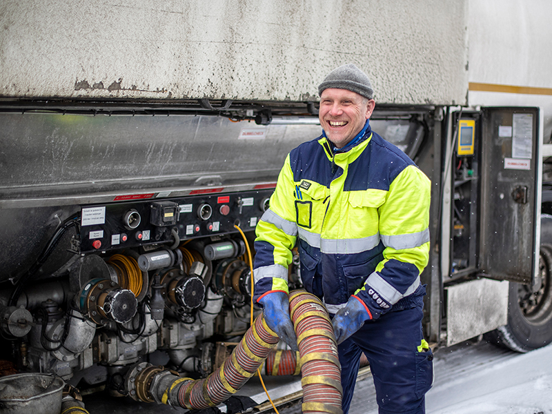 Man hanterar slangar vid tankbil