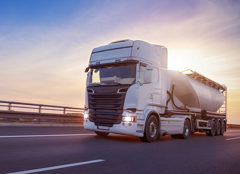 Loaded European truck tank on motorway in beautiful sunset light