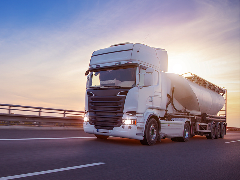 Loaded European truck tank on motorway in beautiful sunset light