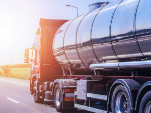 Big gas-tank goes on highway against the sky