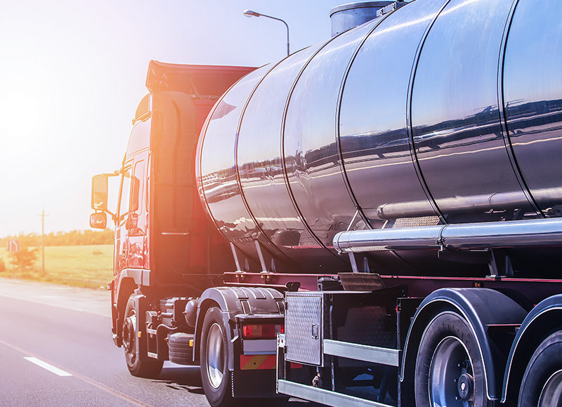 Big gas-tank goes on highway against the sky