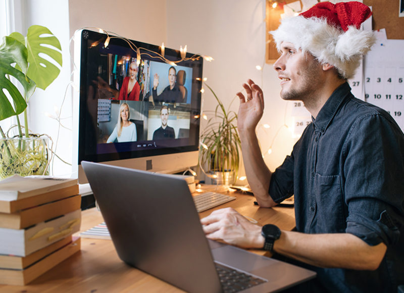 Christmas day remote celebration. Young man having Zoom video ca